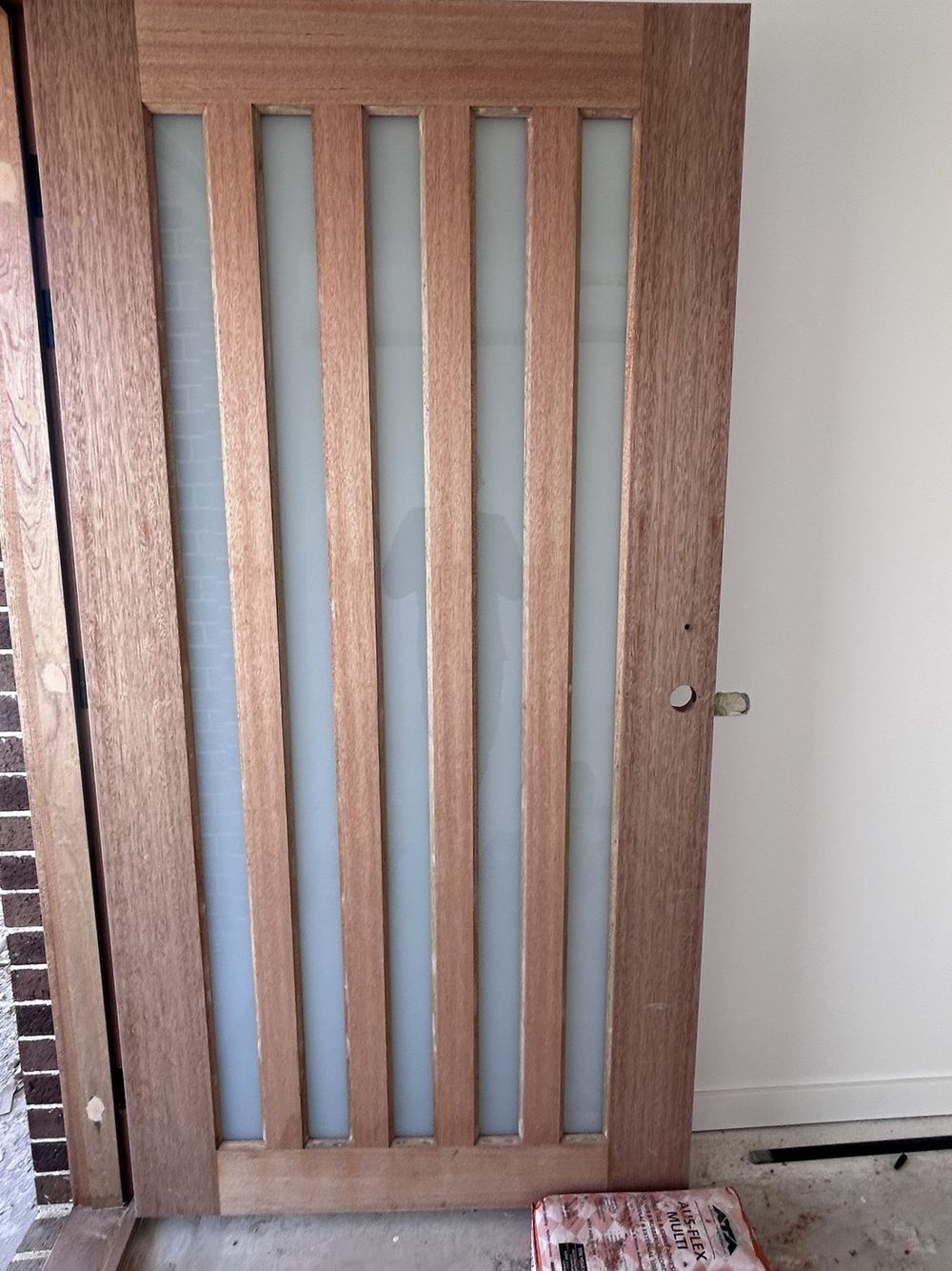 Slat entry door, new home, before